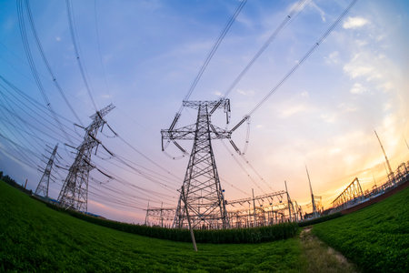 The pylons are in the evening, Substation in the evening, the silhouette of the power supply facilities, High voltage substation and beautiful sunset glowの写真素材