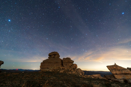 The strange rocks on the mountain are under the stars, the mountain is under the Milky Wayの写真素材