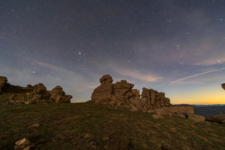 The strange rocks on the mountain are under the stars, the mountain is under the Milky Wayの写真素材