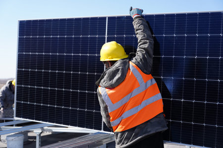 Workers install solar photovoltaic panels, Workers repair solar photovoltaic power generation...