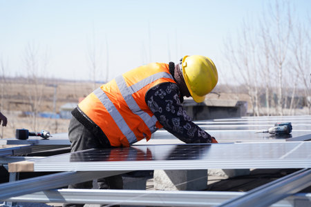 Workers install solar photovoltaic panels, Workers repair solar photovoltaic power generation equipmentの写真素材
