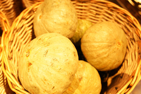 The pumpkin is in the bamboo basket, close-upの写真素材