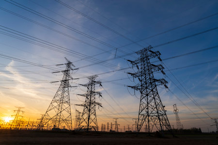 The pylons are in the evening, Substation in the evening, the silhouette of the power supply facilities, High voltage substation and beautiful sunset glowの写真素材