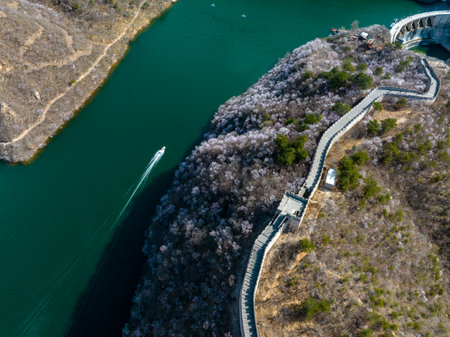 The Great Wall is in China. The Great Wall in spring, the mountains are full of flowers, the Great Wall and the lakeの写真素材