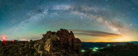 The strange rocks on the mountain are under the stars. the mountain is under the Milky Wayの写真素材
