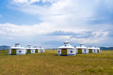 The yurt is under the blue sky and white clouds, yurts in the beautiful grassland, Mongolian yurt on the grassland.の写真素材