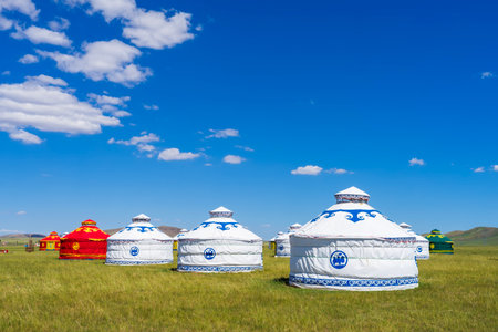 The yurt is under the blue sky and white clouds, yurts in the beautiful grassland, Mongolian yurt on the grassland.の写真素材