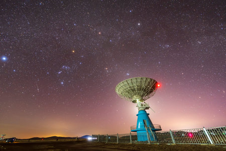 In observatories, satellite antenna radio telescope on the background of stellar tracks, radio...