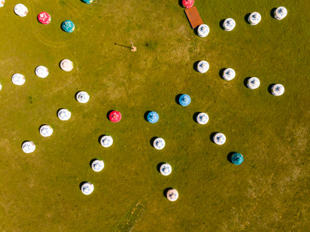 The yurt is under the blue sky and white clouds, yurts in the beautiful grassland, Mongolian yurt on the grassland. Drone aerial photographyの写真素材
