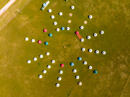 The yurt is under the blue sky and white clouds, yurts in the beautiful grassland, Mongolian yurt on the grassland. Drone aerial photographyの写真素材