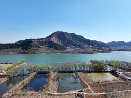 In spring, the beautiful river and the distant mountainsの写真素材