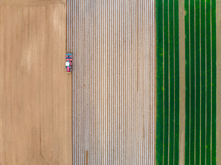 In spring, farmers use farm machinery to cultivate fields. Farmers use tractors for cultivationの写真素材