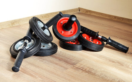 rollers for the press, one roller assembled and the other handle from the wheels separately, lying...