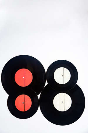 Vintage vinyl records of different diameters on a white backgroundの写真素材