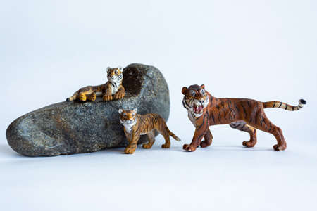 Tiger toy with tiger cubs on a white backgroundの写真素材