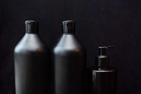 Black bubbles with cosmetic product on a black background. Shampoo, shower gel, soap, or body lotionの写真素材