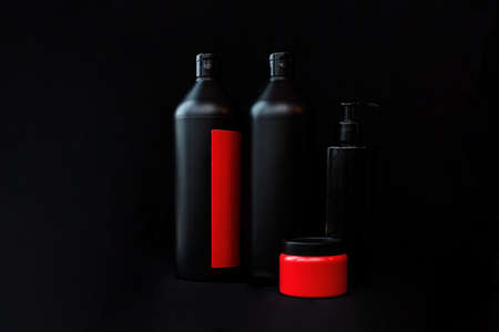 Black and red bubbles with cosmetic product on a black background. Shampoo, shower gel, soap, or body lotionの写真素材