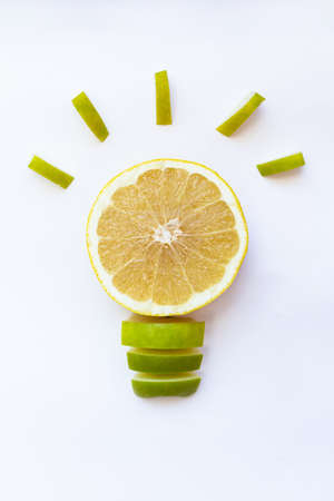 Idea. Light bulb from grapefruit and apple on a white backgroundの写真素材