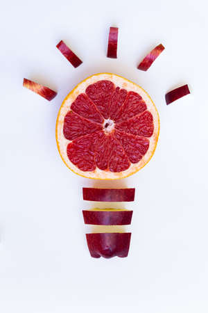 Idea. Light bulb from grapefruit and apple on a white backgroundの写真素材