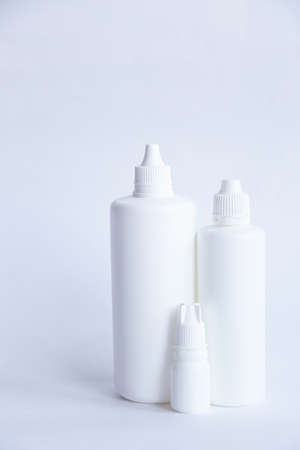 Contact lenses lens care products in white bottles on white background lens containersの写真素材