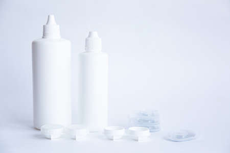 Contact lenses lens care products in white bottles on white background lens containersの写真素材
