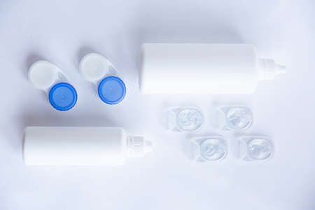 Contact lenses lens care products in white bottles on white background lens containersの写真素材