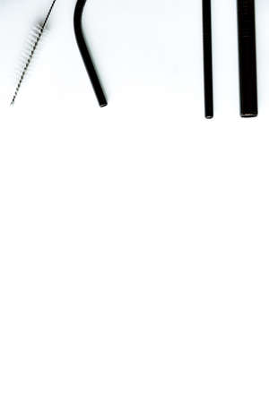Black metal reusable straws for drinks on white background no plasticの写真素材