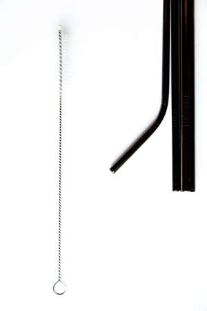 Black metal reusable straws for drinks on white background no plasticの写真素材