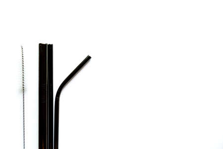 Black metal reusable straws for drinks on white background no plasticの写真素材