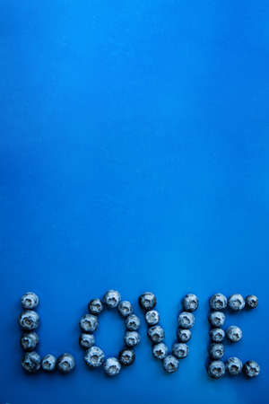 Love made with fresh blueberries on  blueの写真素材