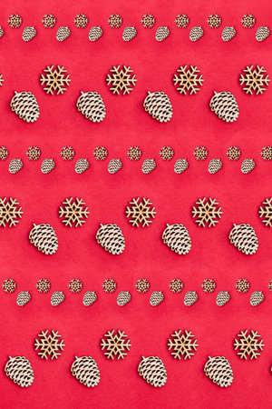 Christmas pattern with snowflakes and cones on a red background. Festive winter background
