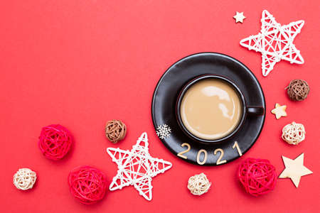 Christmas composition numbers 2021 and a cup of coffee on a red background. New year 2021 and Christmas conceptの写真素材