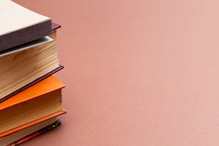 Stack of books on a beige background. Vintage books with copy spaceの写真素材