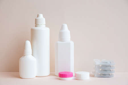 Contact lenses and lens care products on light pink backgroundの写真素材