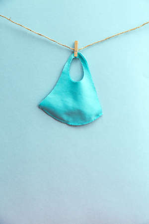 The reusable protective cloth mask is hanging. The face mask dries after washing. Mask to protect against covid-19 virus and other respiratory diseasesの写真素材