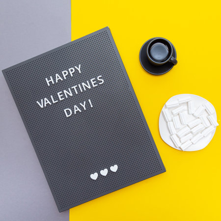 Happy Valentine's Day! Flat lay on a gray-yellow surface. Mock up greeting card or invitation with copy spaceの写真素材
