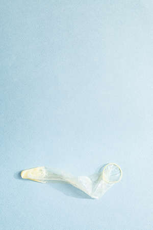 Used condom. The minimal concept of safe sex on the blue background. World AIDS Day.の写真素材