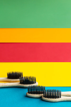 Composition of organic bamboo toothbrushes on the bright multi colored background. Natural oral...