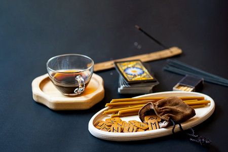 Modern, minimal still life with runes and tarot cards on table. Magic ritual, esoteric and occult...