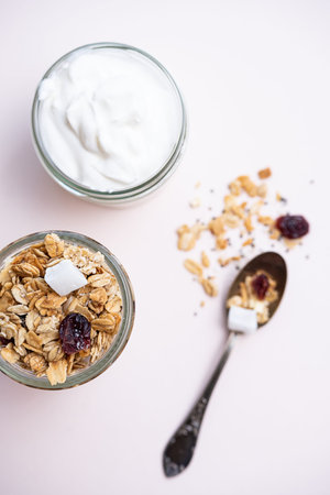 Healthy breakfast concept. Granola with cranberries, coconut, chia seeds and Greek yogurt....