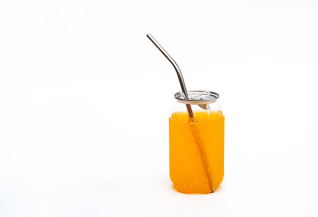 Transparent tin with fizzy pop drink. Can of carbonated citrus beverage, with reusable metal straw....