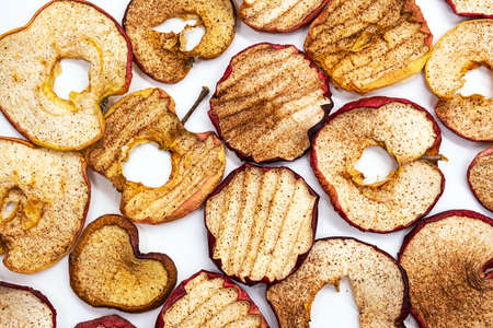 Dried apples with cinnamon, healthy snack. Slices of dried fruits, superfood. Vegan and raw food diet concept.の写真素材