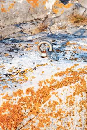Ð¡limbing carabiner hook and trigger device in stone. Carabiner for mountaineering on rocky...
