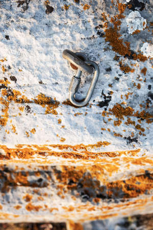 Ð¡limbing carabiner hook and trigger device in stone. Carabiner for mountaineering on rocky background . Extreme sport concept.の写真素材