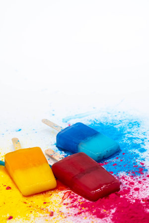 Colored ice creams against multicolores explosion paint. Various bright ice cream. Summer concept.の写真素材