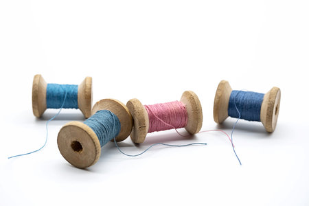 Colorful threads for sewing. Different threads on wooden vintage reels.の写真素材