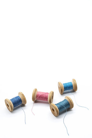 Colorful threads for sewing. Different threads on wooden vintage reels.の写真素材