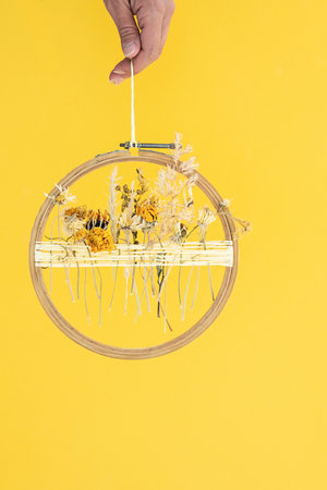 Dried flower decoration. DIY floral door wreath from yellow dry summer flowers.の写真素材