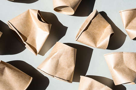 Some used disposable paper coffee cup. Mock up crumpled to go coffee cups with shadow, top view.の写真素材