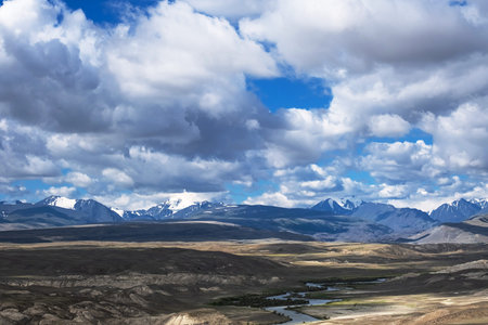 Majestic snow mountain ranges under cloudy sky. Awesome scenery high snow mountains valley...